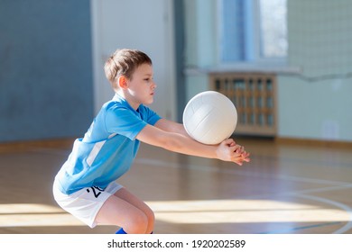 School kid playing volleyball in a physical education lesson. Safe back to school during pandemic concept