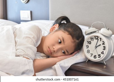 School Kid Suffering Insomnia (sleeping Disorder), Mental Health Illness Concept With Asian Girl Child Cannot Sleep On Bed At Night In Bedroom 