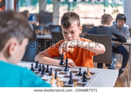 A school kid taking part in a chess tournament 