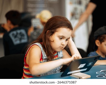 School kids in class using a digital tablet.