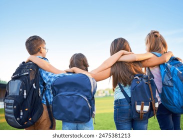 School kids, group and back with hug, outdoor and together with support, solidarity and development. Children, link and friends for learning, education and future with backpack on lawn at academy - Powered by Shutterstock