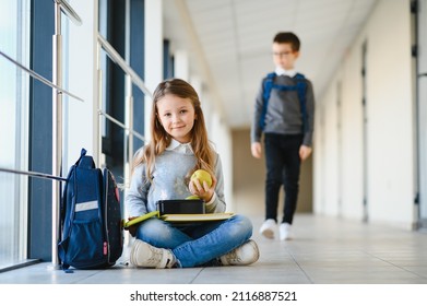 School kids reading book together in corridor. Conception of education. - Powered by Shutterstock