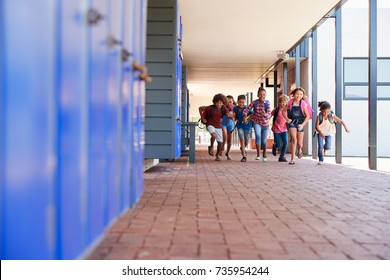 School Kids Running To Camera In Elementary School Hallway