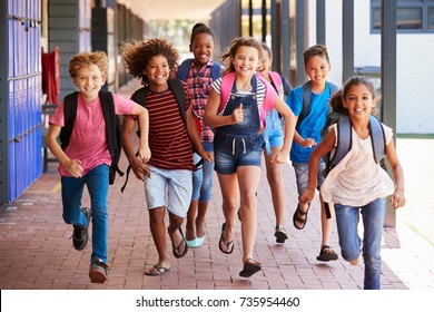 School Kids Running In Elementary School Hallway, Front View