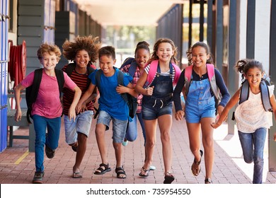 School Kids Running In Elementary School Hallway, Front View