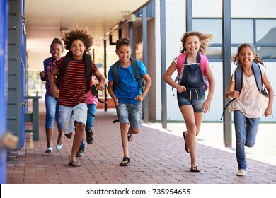 School kids running in elementary school hallway, front view - Shutterstock ID 735954655