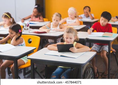 School Kids Studying In Classroom At School