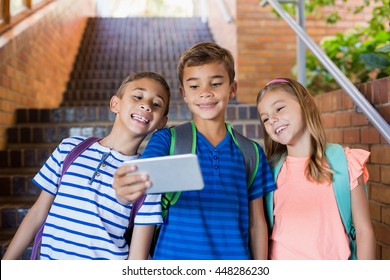 School kids taking selfie from mobile phone at school - Powered by Shutterstock