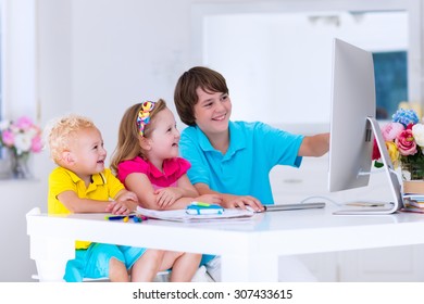 School Kids Working On Personal Computer At Home. Student Doing Homework Using Modern Pc In Classroom. Kids Studying With Digital Devices. Children Study In White Class Room. Child Learning.