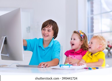 School Kids Working On Personal Computer At Home. Student Doing Homework Using Modern Pc In Classroom. Kids Studying With Digital Devices. Children Study In White Class Room. Child Learning.