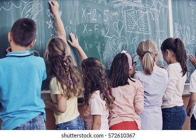 School Kids Writing On Board