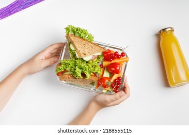 School lunch in box, container. Small kid's meal, take away school food. Toasts, sandwiches, vegetable snack. Healthy food for school. Top view.