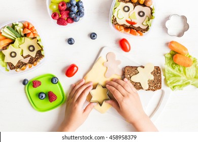 School lunch box for kids. Back to school. Cooking. Child's hands. Top view, flat lay