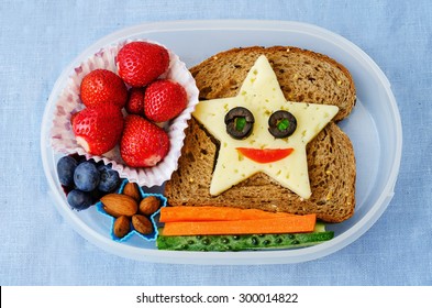 school lunch box for kids with food in the form of funny faces. the toning. selective focus - Shutterstock ID 300014822