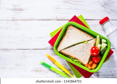 School Lunch Box And Stationery On White Wooden Table. 