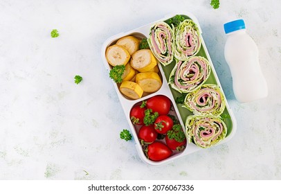 School Lunchbox. Healthy Lunch Box With Tortilla Wraps, Tomatoes, Banana And Yogurt. Top View, Flat Lay