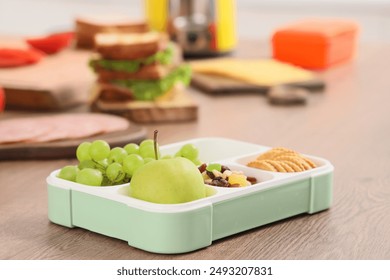 School lunchbox with tasty food on table in kitchen, closeup - Powered by Shutterstock