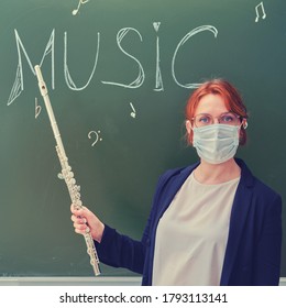 School Music Teacher In A Medical Mask. Woman Teaches Playing Musical Instruments During Quarantine