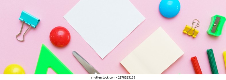 School Note And Landing On Pink Background. Back To School, Home Study Creative Workspace, Painting Supplies, Pencils, Paint Pens And More