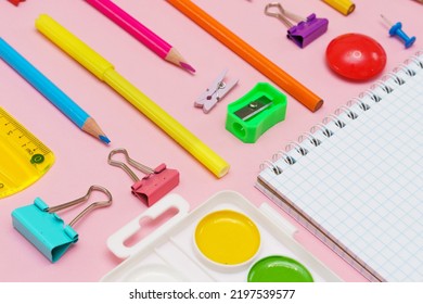 School Note And Landing On Pink Background. Back To School, Home Study Creative Workspace, Painting Supplies, Pencils, Paint Pens And More