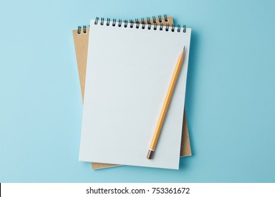 school notebook on a blue background, spiral notepad on a table - Shutterstock ID 753361672