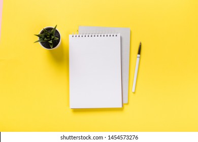 School Notebook On A Yellow Background, Spiral Notepad On A Table. Flatlay