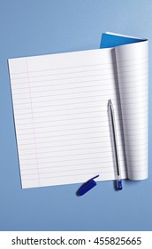 School Notebook And Pen On Blue Table, Top View 