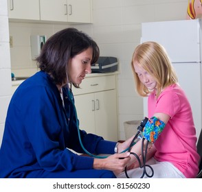 School Nurse Checking Blood Pressure Of Student Patient