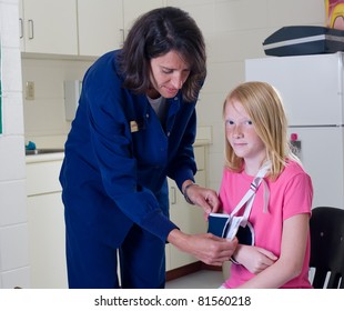 School Nurse Checking A Sling For Broken Arm On Student Patient