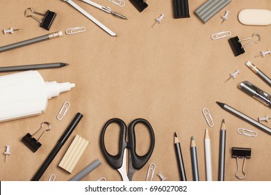 School Or Office Supplies In Black, Gray And White Colors On A Craft Background. The Concept Of Minimalism, Creativity, Learning, Work. Flat Lay