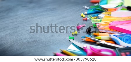 School and office supplies on blackboard
