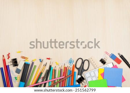 School and office supplies over office table. Top view with copy space
