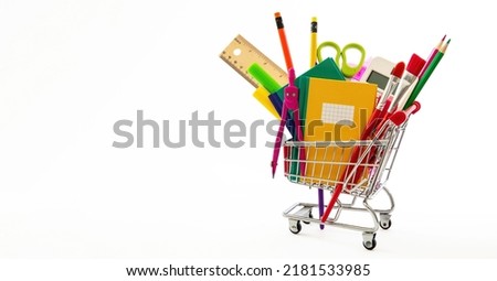 School office supplies and stationery in a shopping trolley isolated on white color, copy space. Back to school concept