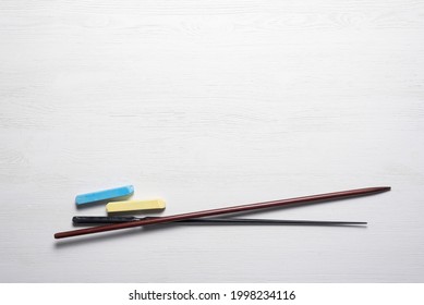 School Pointer And Chalk On The White Teacher Flat Lay Desk Background With Copy Space. Back To School.