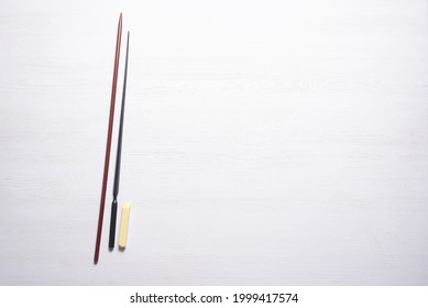 School Pointer And Chalk On The White Teacher Flat Lay Desk Background With Copy Space. Back To School.