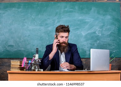 School Principal Or Teacher Calling Parents To Report About Exam Results. School Teacher Cares About Communication With Parents. Man With Beard Talk Phone Classroom Background. In Touch With School.