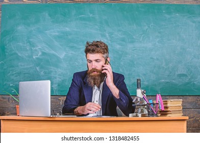 School Principal Or Teacher Calling Parents To Report About Exam Results. School Teacher Cares About Communication With Parents. Man With Beard Talk Phone Classroom Background. In Touch With School.