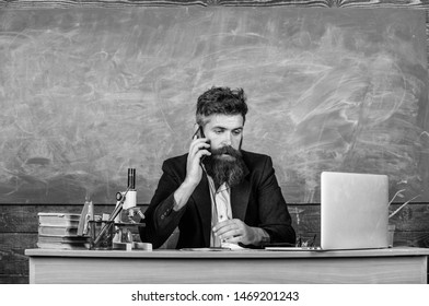 School Principal Or Teacher Calling Parents To Report About Exam Results. School Teacher Cares About Communication With Parents. Man With Beard Talk Phone Classroom Background. In Touch With School.