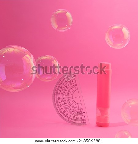 School protractor and marker flying with transparent balloons. Pink dreamy background scene. Supplies for classroom learning concept. Fantasy neon aesthetic design idea. Education student table