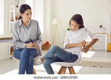 School psychologist talking to child with behavior issues. Therapist trying to find approach to kid. Rebellious teenager refusing to have conversation and showing disrespect during appointment visit