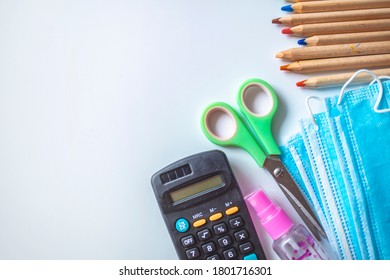 School reopening, returning back to school for post covid-19 coronavirus pandemic, new normal concept. Useful for the return to school and mask on a blue background. Copy space. 