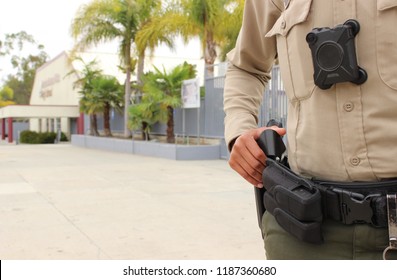 School Safety Concept - Armed Police Officer On Duty Protecting A Closed Campus High School In California