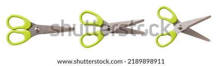 School scissors closed open and wide open, green plastic handle isolated on white. Kids creativity safe tool top view
