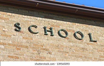 School sign on a brick wall - Shutterstock ID 139565093