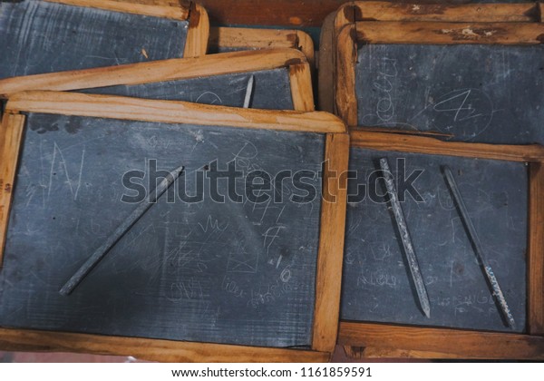 School slate: School slate used\
for writing practice and arithmetic. Students wrote on the slate\
with a \