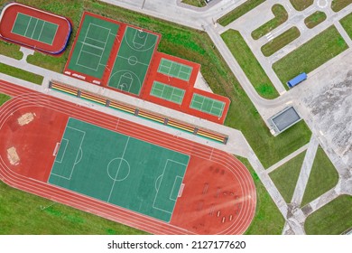 School Sports Ground With Football Stadium, Jogging Tracks Around. Basketball, Volleyball, Tennis Courts. Aerial Photo, Top View.