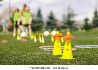 School Sports Training Equipment. Children play sports outdoors at the school's soccer field. Kids Exercising at Obstacle Course - Powered by Shutterstock