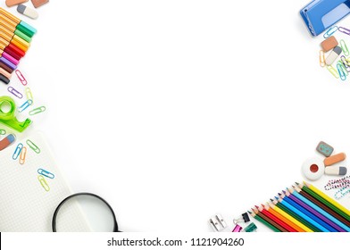 School stationery materials such as crayons, markers, clips, puncher, magnifying glass, erasers on white office table desk. Top view, flat lay with copy space - Shutterstock ID 1121904260