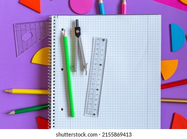 School stationery on violet background. Colorful math fractions, rulers, open notepad on a purple background. Interesting, fun math for kids. Education, back to school concept - Powered by Shutterstock