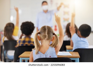 School students raising hands to volunteer, participate and answer during lesson while learning in a classroom. Teacher asking questions to eager, smart and clever young kids questions for education - Powered by Shutterstock